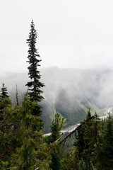 distant landscape view of mountains shrouded in fog and clouds