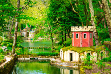 Beautiful garden near the Pena Palace. The green park in Sintra, Portugal with architecture.  - obrazy, fototapety, plakaty