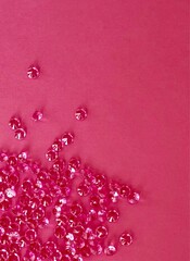 pink plastic jewels on pink paper