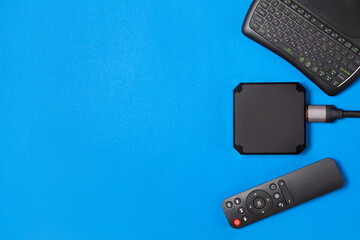TV box and remote controls for ip tv and digital video content on a blue background