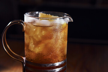 Ice cubes inside. Close up view of fresh summer cocktail on the wooden table