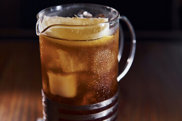 Ice cubes inside. Close up view of fresh summer cocktail on the wooden table