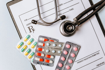 Medical concept flat lay with stethoscope, pills, notepad on the doctor desktop