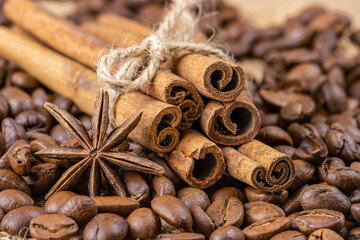 Obraz na płótnie Canvas Close-up of fragrant cinnamon sticks, anise star and roasted coffee beans. Macro ingredients. Selective focus
