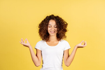 Young afro american woman on yellow copy space background