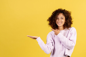 Young african american woman on yellow copy space background