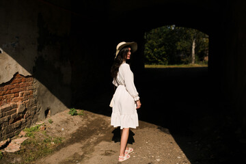 girl walking in a hat in summer 