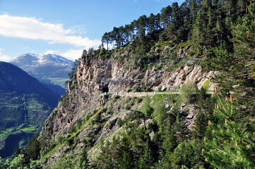 Mountain landscape Mountain road leading to the tunnel. Rocks, panorama.