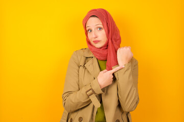 MODEL in hurry pointing to watch time, impatience, upset and angry for deadline delay