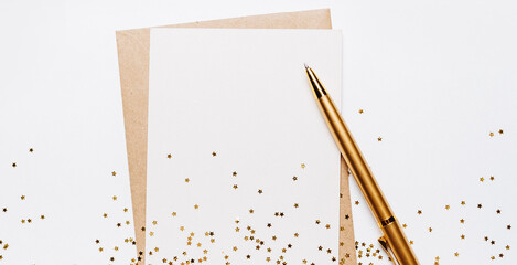 Blank note with envelope, pen and gold glitter stars on white background