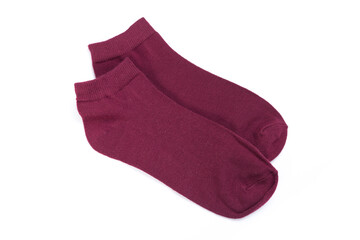 Pair of burgundy short socks on white background, top view