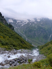 Fototapeta na wymiar Flooding on the hiking trail, Berlin high path, Zillertal Alps in Tyrol, Austria