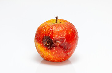 rotten apple with eyes isolated on white. Moldy, Withered and spoiled apple fruits with a disease.