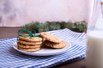 New Year's content with baked cookies, milk, gifts, toy for the Christmas tree, Christmas tree twigs, view from above. Place for text.