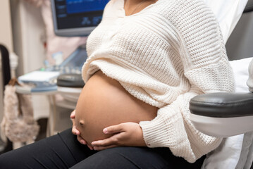 Young Pregnant Black Woman getting ultrasound, 8 months pregnant