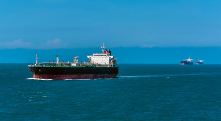 Tankers sailing along a channel in the Singapore Straits in Asia in summertime