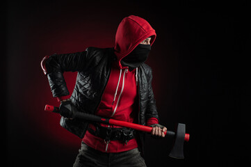 a man in a Balaclava and hoodie with an axe the image of a Protestant