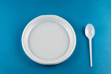 plastic plate spoon on a blue background