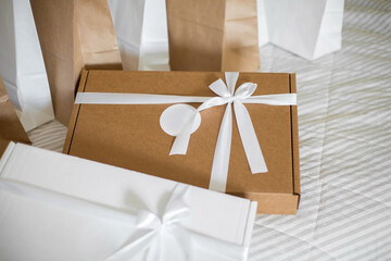 Brown and white Empty Kraft Paper Bags on fabric background. Packaging template mockup