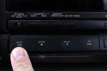 Press Rew button on retro audio cassette tape recorder.