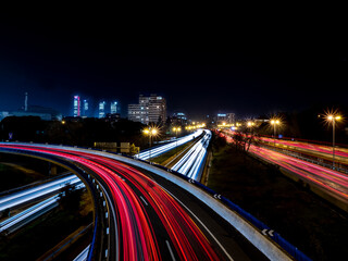 Light trails produced at dusk by the headlights and tail lights of cars from a bridge