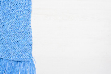 Blue scarf on the white wooden table background.