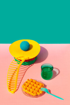 Waffle, juice, banana shape and rubber ball kept on basket