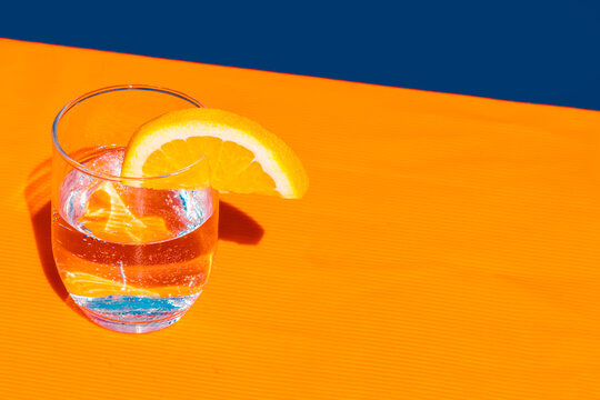 Studio shot of glass of soda with slice of lemon