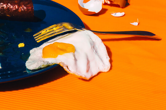 Fried egg spiling over plate