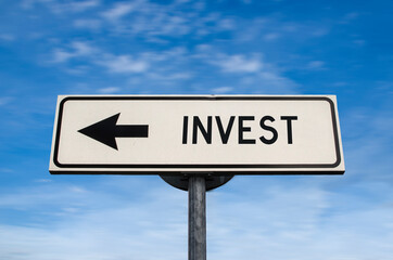 Invest road sign, arrow on blue sky background. One way blank road sign with copy space. Arrow on a...