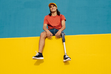 Athlete smiling while sitting on multi colored wall