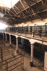 Young man exploring an abandoned industrial building.