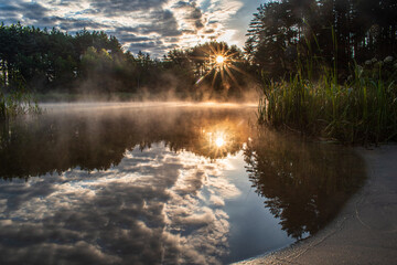 Beautiful summer landscape. Foggy morning sunrise. Colorful bright sun over the lake ... Ukraine Novoyavorivsk