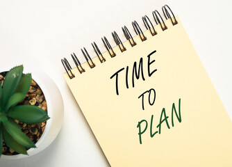 Time to plan inscription on notebook on office table
