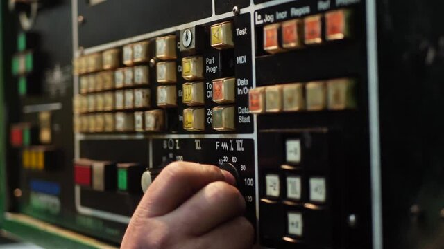 Industrial remote CNC control panel of machinery with different buttons at cutting metal factory. Operation of lathe machine. Heavy industry, factory manufacturing concept