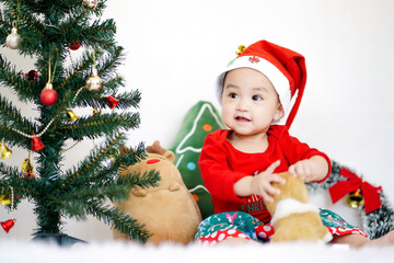 Asian cute baby girl in Christmas costume on white background