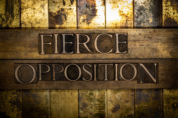 Fierce Opposition text on copper bars over textured golden background