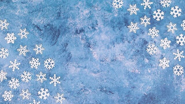Snowflakes move on corner of blue icy theme. Stop motion