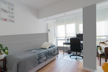 Teenager room in grey color with space for studying and a piano