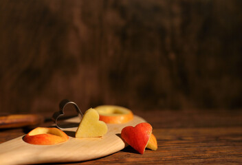 Fototapeta na wymiar red apple heart for valentine's day on wooden background