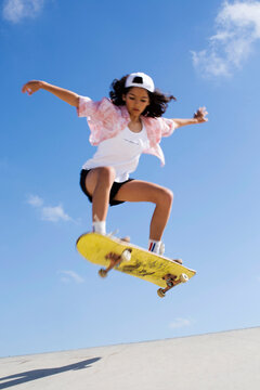 Teen-girl make an ollie on a skateboard