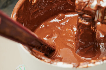Mixing ingredients in a small-scale wholesale chocolate and confectionery machine in  small business