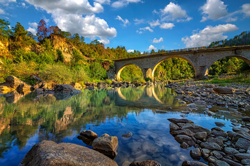 amazing view of the peaceful river and old stone bridge