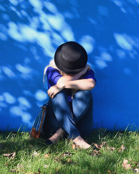 Girl Hiding Face Outside with Sun Shadows