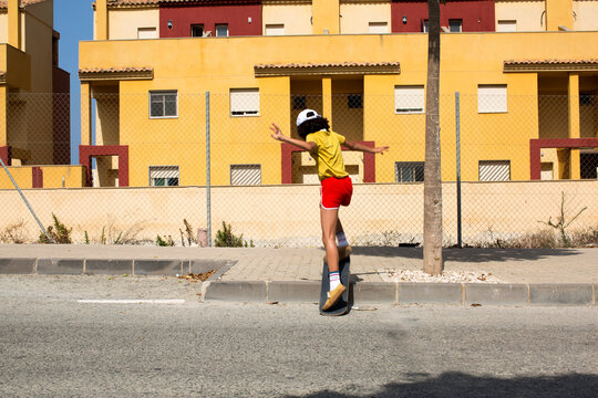 Stylish girl doing a skateboard trick.