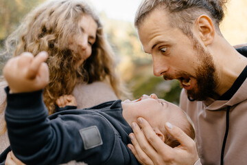 young dad tries to calm crying baby