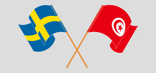 Crossed and waving flags of Sweden and Tunisia