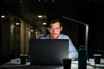 Focused businessman working late in office