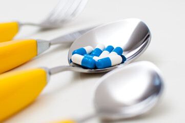 Dinner set with pills on white background