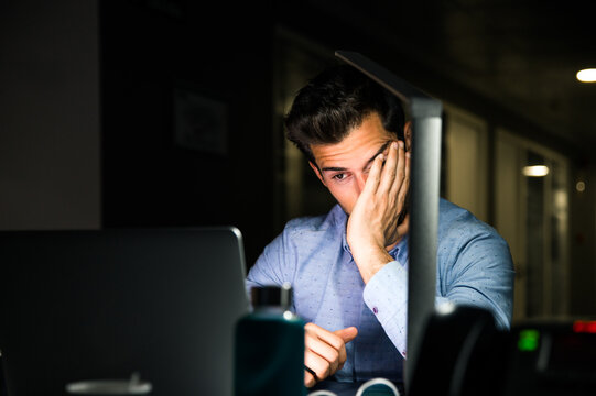 Tired businessman working late in office